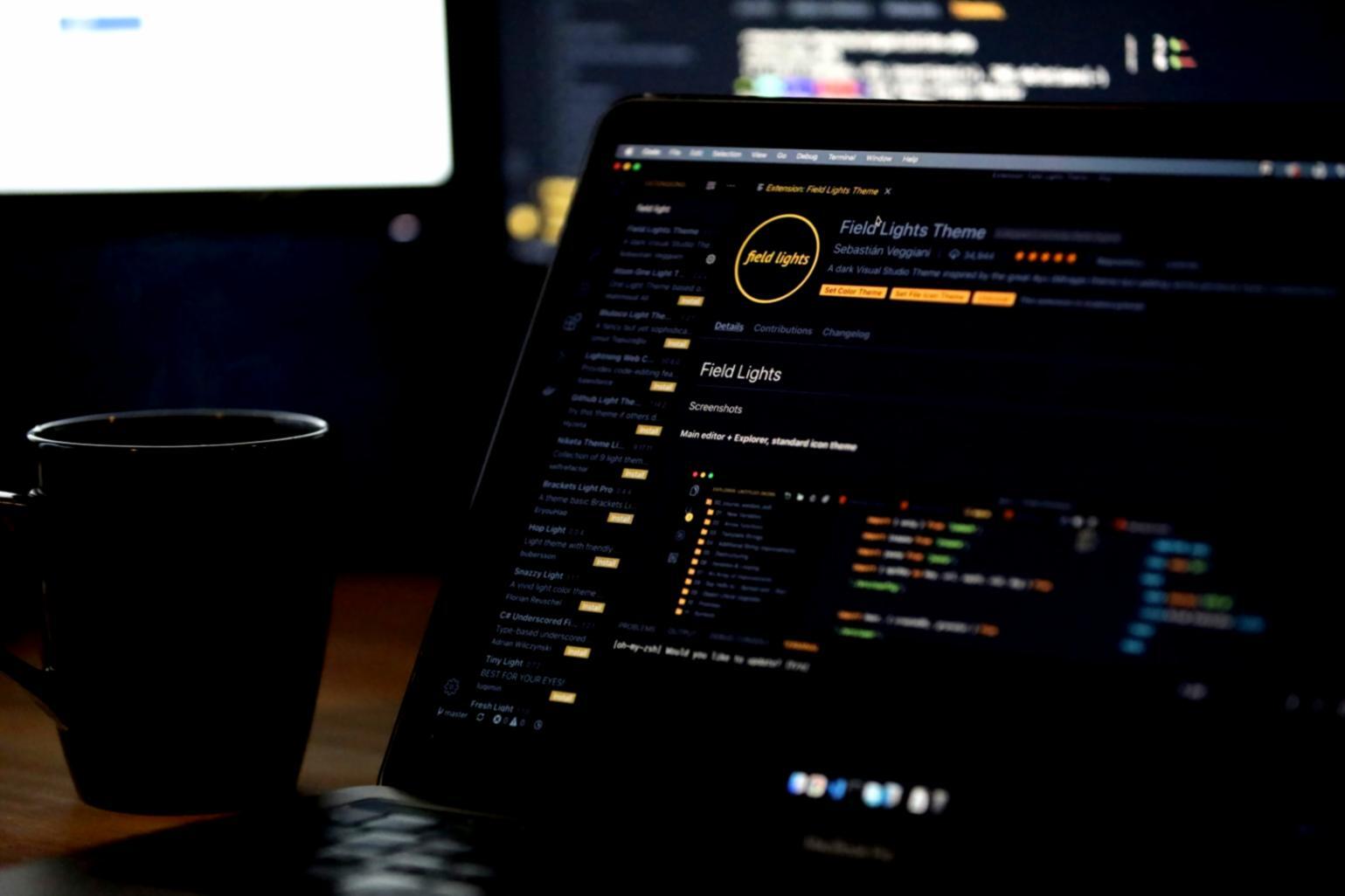 Students working on mobile app development projects during intensive coding session